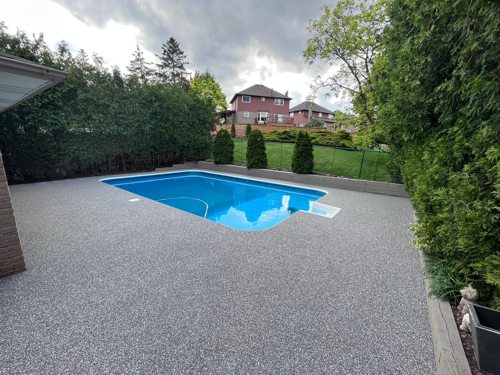 Modern gray white residential pool deck with rubber safety surface