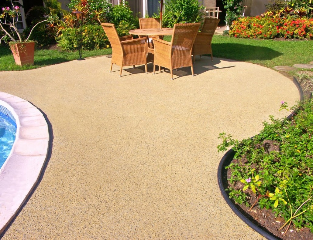 Outdoor patio seating area with wicker dining furniture and rubber safety surface