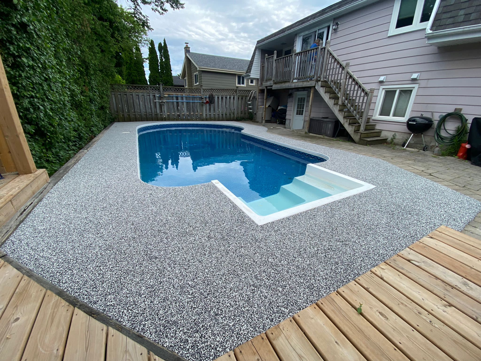 Gray and white pool deck rubber safety surface angle view