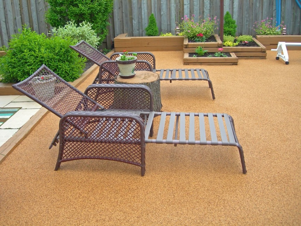Patio lounge area with chaise lounges and rubber safety surface